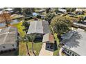Single-story home with metal roof, carport, and waterfront access at 34205 Island Dr, Leesburg, FL 34788