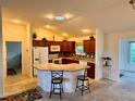 Open kitchen features an island with bar seating and recessed lighting at 3554 Oracle Ct, The Villages, FL 32163