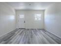 Living room with vinyl plank flooring and white door at 368 Justice St, Bushnell, FL 33513