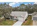 Single-story house with a gray roof, and a spacious yard at 5505 Tangelo St, Leesburg, FL 34748