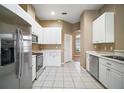 Kitchen with stainless steel appliances and white cabinets at 5616 Illumination Ln, Leesburg, FL 34748