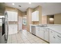 Kitchen with stainless steel appliances and white cabinets at 5616 Illumination Ln, Leesburg, FL 34748