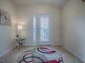 Bright entryway with a glass door and decorative rug at 8633 Se 133Rd Ln, Summerfield, FL 34491