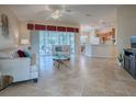 Spacious living room with light tile floors and access to a lanai at 8633 Se 133Rd Ln, Summerfield, FL 34491
