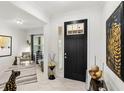 Bright and spacious entryway with a statement black door at 9287 Sw 102Nd Avenue Rd, Ocala, FL 34481