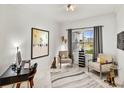 Home office with two armchairs, a desk, and large window at 9287 Sw 102Nd Avenue Rd, Ocala, FL 34481