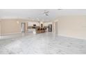Open-concept space with kitchen, dining, and living areas, featuring marble flooring at 9334 Sw 57Th Ave, Ocala, FL 34476