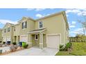 Front view of a two-story townhome with double garage at 961 Lido Dr, Howey In The Hills, FL 34737