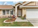 Front entry with door, walkway, and landscaping at 1381 Winterville St, Deltona, FL 32725