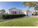 One-story house with a two-car garage and lush landscaping at 17030 Se 79Th Clearview Ave, The Villages, FL 32162