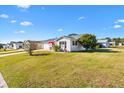 Side view of a house showing the yard and neighborhood at 1842 Captiva Ct, The Villages, FL 32162