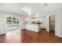 Kitchen with white cabinets, breakfast bar, and tile floor at 2121 Croat St, Mount Dora, FL 32757