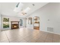 Bright living room with fireplace and vaulted ceiling, kitchen view at 2121 Croat St, Mount Dora, FL 32757