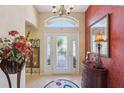 Elegant entryway with a decorative console table and rich wall color at 2134 Zaragoza Pl, Lady Lake, FL 32159