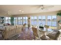 Bright sunroom with lake views, wicker furniture, and tile flooring at 2134 Zaragoza Pl, The Villages, FL 32159