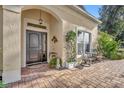 Brick walkway leading to a dark brown front door with sidelights at 214 Forest Park Ln, Lady Lake, FL 32159