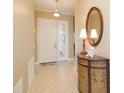 Bright entryway with tiled floors, a half-round table, and a mirror at 2298 Caledonian St, Clermont, FL 34711