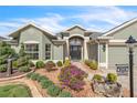 Landscaped front yard with walkway leading to the house entrance at 2532 Edenville Path, The Villages, FL 32162