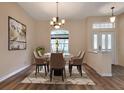 Formal dining room with chandelier and hardwood floors at 26908 Honeymoon Ave, Leesburg, FL 34748