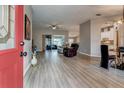 Bright and spacious entryway with hardwood floors, leading to living room at 27302 Orchid Glade St, Leesburg, FL 34748