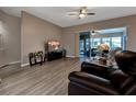 Living room with hardwood floors, sliding glass doors to lanai at 27302 Orchid Glade St, Leesburg, FL 34748