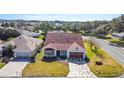 Single-Gathering home with red roof and geometric driveway at 2762 Morven Park Way, The Villages, FL 32162