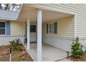 Covered front porch with white columns and a charming entrance at 312 Brigadoon Cir # 312, Leesburg, FL 34788