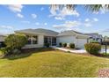 Single-story house with a well-maintained lawn and landscaping at 3488 Sterling St, The Villages, FL 32162