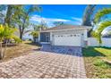 This charming house features a paver driveway and screened-in porch at 415 Renee Dr, Haines City, FL 33844