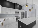 Modern kitchen with white cabinets, marble countertops, and a large island at 42025 Royal Trails Rd, Eustis, FL 32736