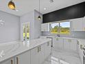 Modern kitchen with white cabinets and marble countertops at 42025 Royal Trails Rd, Eustis, FL 32736