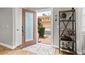 Bright and airy entryway with a wooden shelf and a view of the front walkway at 5448 Via Appia Way, Sanford, FL 32771