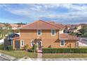 Rear view of a two-story townhome with a screened enclosure and well-maintained landscaping at 5448 Via Appia Way, Sanford, FL 32771