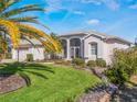 Well-maintained single-story home with manicured lawn, mature shrubbery and a screened porch at 5502 Bounty Cir, Tavares, FL 32778