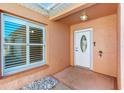 Inviting entryway with a white front door, sidelight, and a window showcasing a bright interior at 629 Nuevo Leon Ln, The Villages, FL 32159