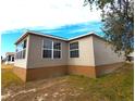 Rear view of the home, highlighting a sunroom addition at 9616 Se 168Th Elderberry Pl, The Villages, FL 32162