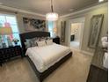 Spacious main bedroom with plush carpet and ensuite bathroom access at 9918 Fiddley Aly, Orlando, FL 32827