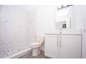 Bathroom featuring a modern vanity, toilet, and marble-look tiled shower at Lot 42 Indian Estates Cr 423, Lake Panasoffkee, FL 33538