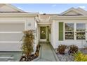 Front entry with green door and walkway at 16967 Se 93Rd Cuthbert Cir, The Villages, FL 32162