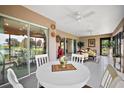 Spacious sunroom with tiled flooring and a white table and chairs at 5911 Delphina Loop, The Villages, FL 32163