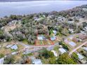 Aerial view of a single story home with a pool, located near a river at 1029 Cr 452A, Lake Panasoffkee, FL 33538