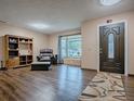 Living room with hardwood floors, comfy seating, and a bay window at 1029 Cr 452A, Lake Panasoffkee, FL 33538