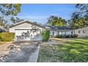 Ranch-style home with attached garage and spacious yard at 1101 Lantana Dr, Eustis, FL 32726