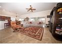 Spacious living room featuring comfortable seating and large windows at 11189 Roz Way, Oxford, FL 34484