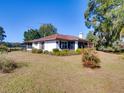 White house with brown roof and screened porch at 1199 Cr 542G, Bushnell, FL 33513