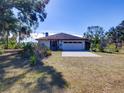 White house with brown roof and attached garage at 1199 Cr 542G, Bushnell, FL 33513