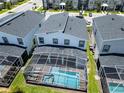 Aerial view of a modern home featuring a screened-in pool and well-maintained backyard at 1257 Challenge Dr, Davenport, FL 33896