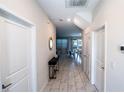 Bright hallway featuring marble-like floors and decorative furnishings leading to a dining area at 1257 Challenge Dr, Davenport, FL 33896