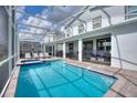 Inviting swimming pool with a covered patio and lounge chairs at 1257 Challenge Dr, Davenport, FL 33896