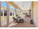 Bright sunroom with comfy seating and access to backyard at 1276 Bennett Pl, The Villages, FL 32162